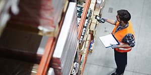 Warehouse worker scanning product for orders
